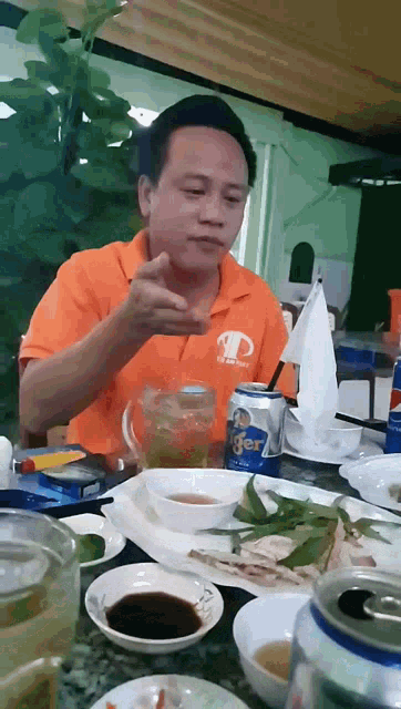 a man wearing an orange shirt with the letter d on it