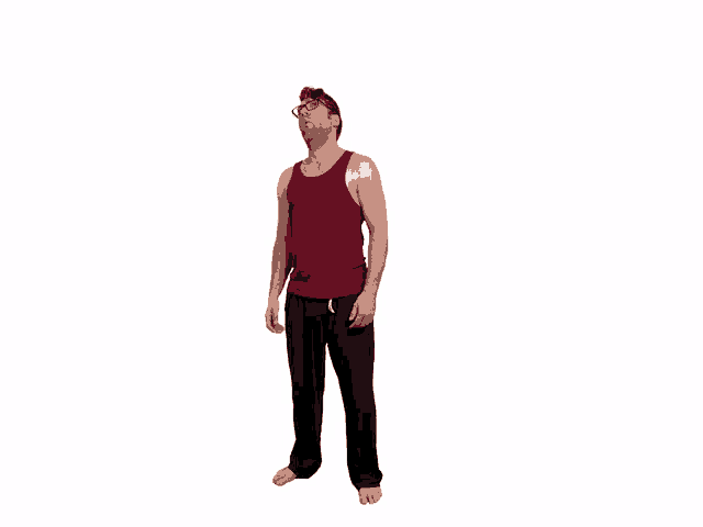 a man wearing a red tank top and black pants is looking up
