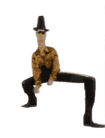 a man wearing a top hat and cowboy boots is sitting on a table .