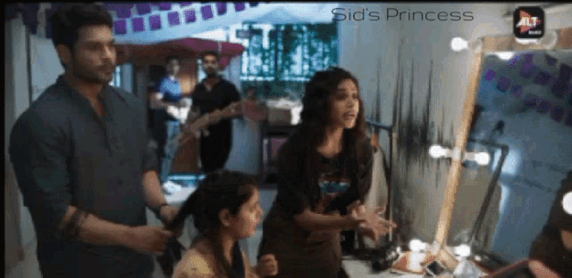 a group of people standing in front of a mirror with sid 's princess written in the corner