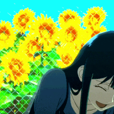 a girl is smiling in front of a fence with sunflowers in the background