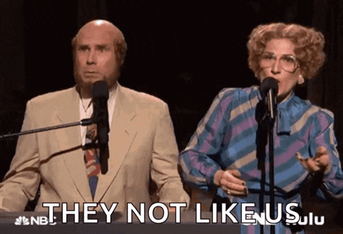 a man and woman singing into microphones with the words they not like us behind them