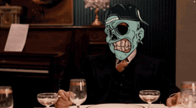 a man with a skeleton mask on his face sits at a table with wine glasses
