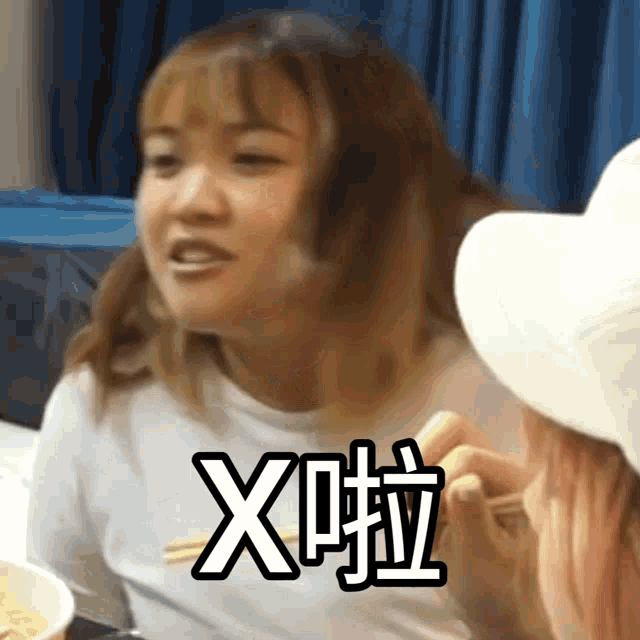 a woman is eating noodles with chopsticks and the word x is on her face
