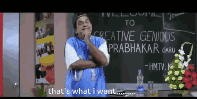 a man is standing in front of a blackboard that says creative genius prabhakar garu