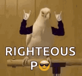 a bird is making a devil horns sign with its arms while sitting on a pipe .