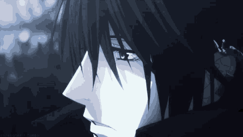 a close up of a person 's face with black hair and blue eyes