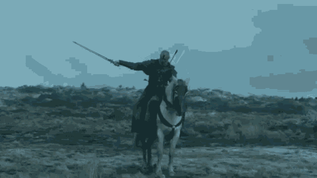 a man riding a horse with a sword in the air