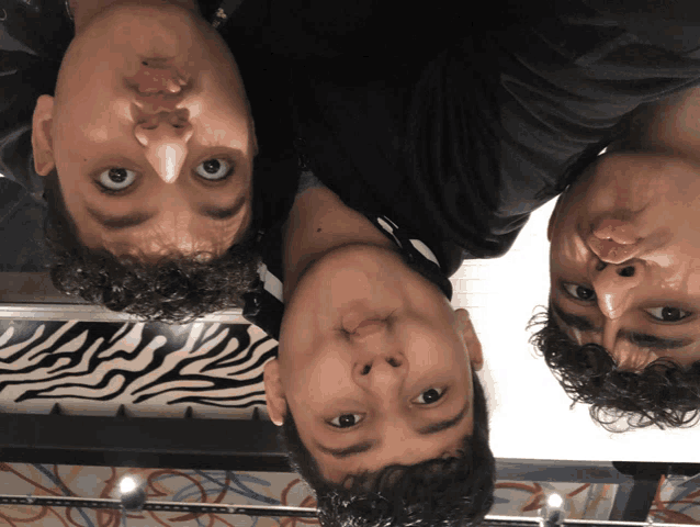 three boys are making funny faces in front of a zebra print wallpaper