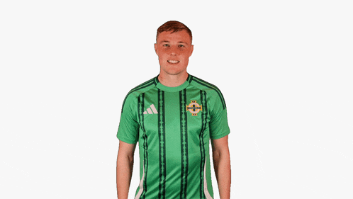a man wearing a green adidas shirt with the word northern ireland on it