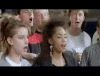 a group of people singing in a choir with a woman in the middle