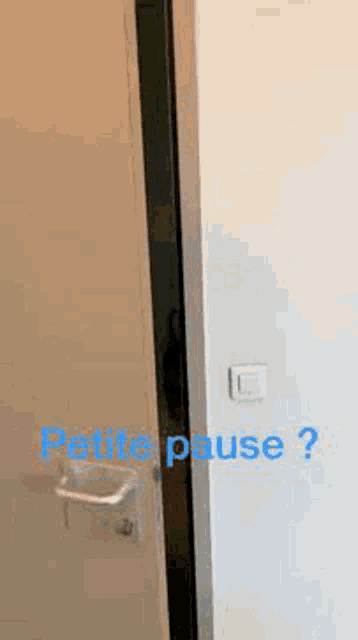 a man with a beard is peeking out from behind a door and asking for a petite pause .