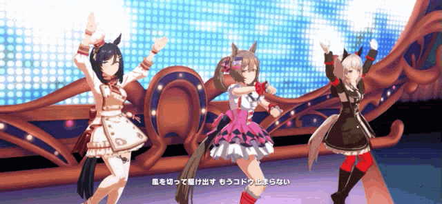 three anime girls are dancing in front of a stage with chinese writing on it