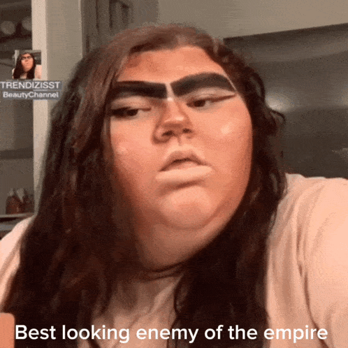 a woman with makeup on her face and the words best looking enemy of the empire