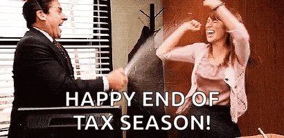 a man and a woman are standing next to each other in an office and celebrating the end of tax season .