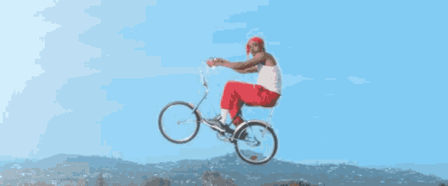 a man is riding a bicycle in the air