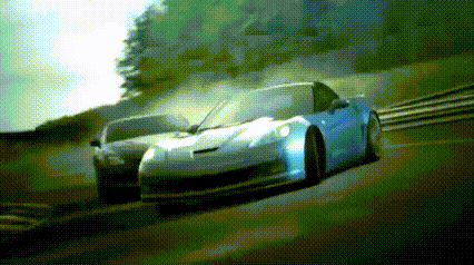 a blue sports car is driving down a road next to another car