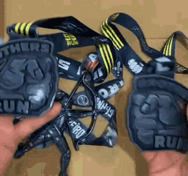 a person is holding a medal that says " others run "