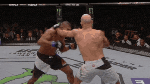 two men are fighting in a boxing ring with a monster energy logo in the background