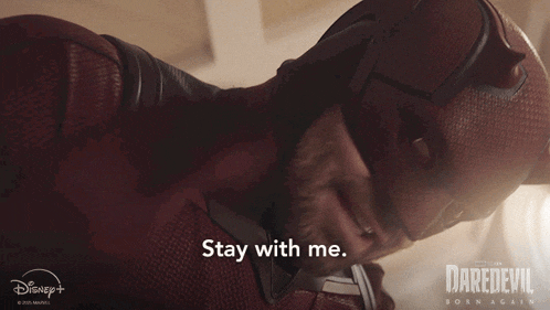 a man in a daredevil costume is saying stay with me