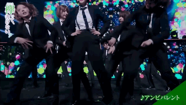 a group of men and women in suits and ties are dancing on a stage