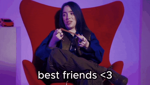 a woman is sitting in a red chair with the words best friends < 3 on the screen
