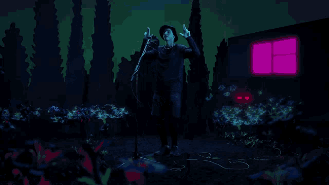 a man in a black hat is singing into a microphone in front of a purple light
