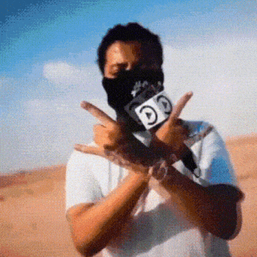 a man wearing a bandana and holding a microphone with a letter g on it