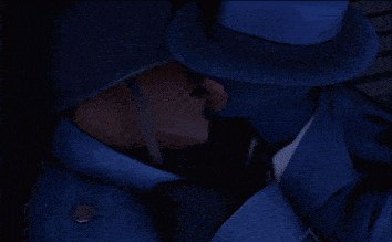 a man in a blue suit and hat is kissing another man
