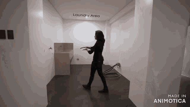 a woman is walking through a laundry area that is made in animatica