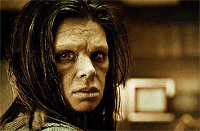 a close up of a woman 's face with a strange look on her face