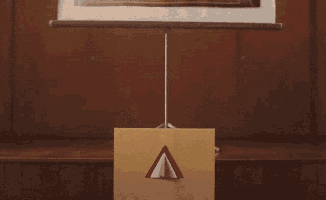 a man stands at a podium with his arms outstretched in front of a podium with the letter a on it