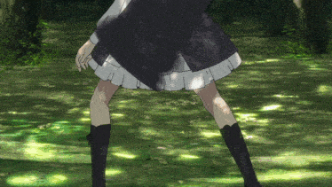 a girl in a black skirt and black boots stands in a grassy area