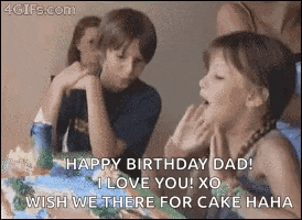 a girl is blowing out a candle on a birthday cake while a boy looks on .