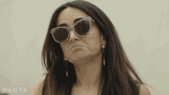 a woman wearing sunglasses is making a funny face and the word pantaya is on the bottom