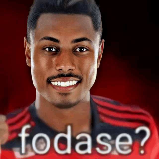 a man wearing a red and black shirt with the word fodase on it