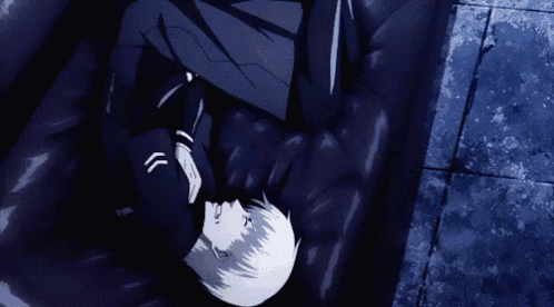 a person is laying on a black couch with their head on the ground .