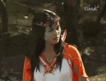 a woman with a scarf around her neck is shown on gma television
