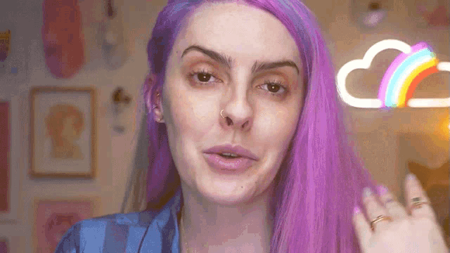a woman with purple hair has a nose ring