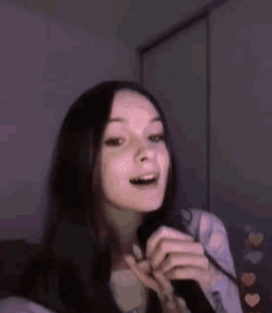 a young woman is making a peace sign with her hands .