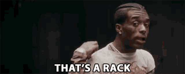 a man is saying `` that 's a rack '' while standing in front of a black background .