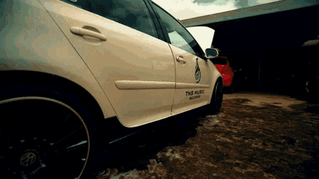 a white car with the words tms music records on it