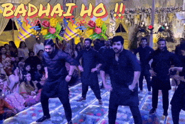 a group of men are dancing in front of a crowd with the words badhai ho written on the bottom