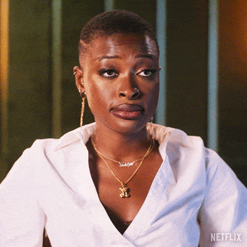 a woman wearing a white shirt and a teddy bear necklace with netflix written on the bottom right