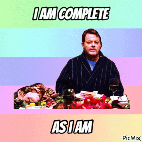 a picture of a man sitting at a table with the words i am complete as i am