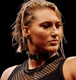 a woman wearing a choker and a black tank top
