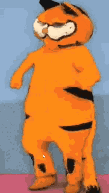 garfield the cat is standing on a pink surface with his arm outstretched
