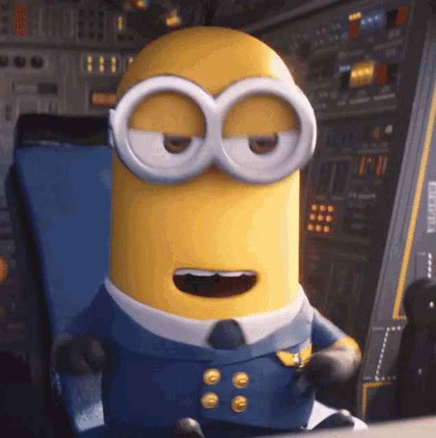 a minion in a blue suit and tie sitting in a chair