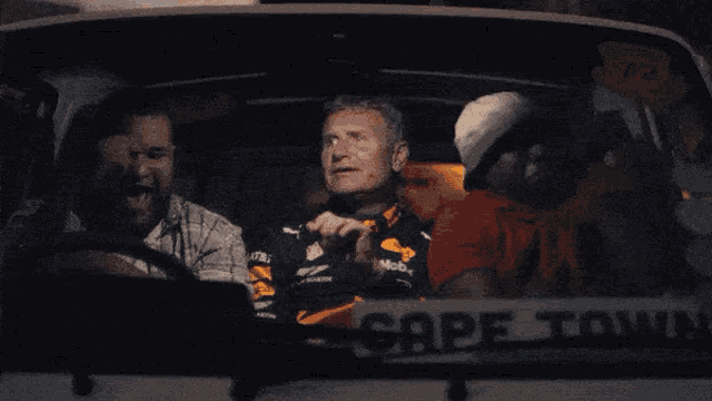 a group of people are sitting in a car with the word cape town on the side