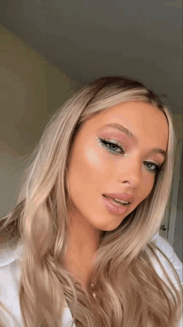 a close up of a woman 's face with makeup on